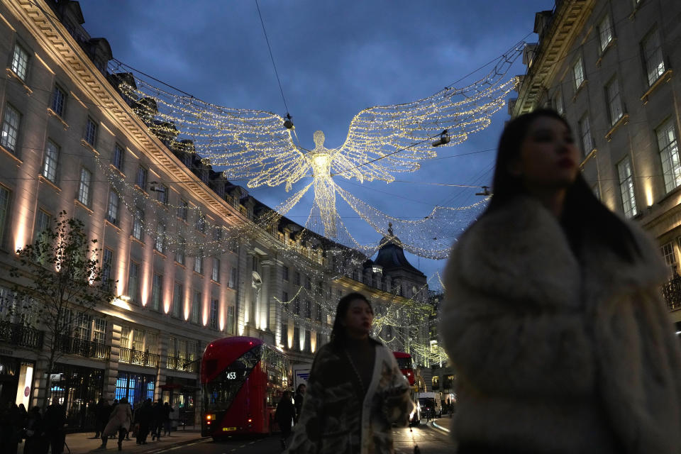 People walk on Regent Street, in London, Thursday, Nov. 17, 2022. Millions of British people face higher taxes and steeper energy bills after the government announced an emergency budget aimed at restoring the government’s economic credibility and shoring up the battered public finances. (AP Photo/Kin Cheung)