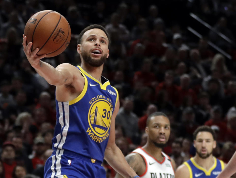 Golden State Warriors guard Stephen Curry (30) holds the ball after being whistled for a penalty during the first half of Game 4 of the NBA basketball playoffs Western Conference finals against the Portland Trail Blazers, Monday, May 20, 2019, in Portland, Ore. (AP Photo/Ted S. Warren)
