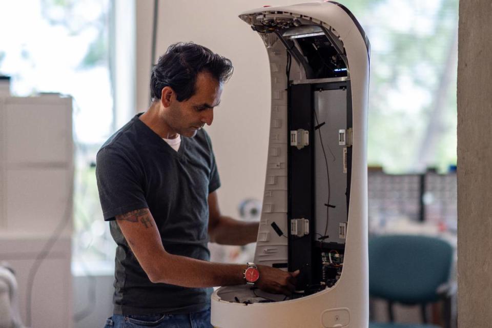 Chetan Patel, co-owner of RobotLAB in Charlotte with his cousin Neel Patel, works on a robot in the warehouse. RobotLAB offers artificial intelligence-powered robots for cleaning, serving and delivery.