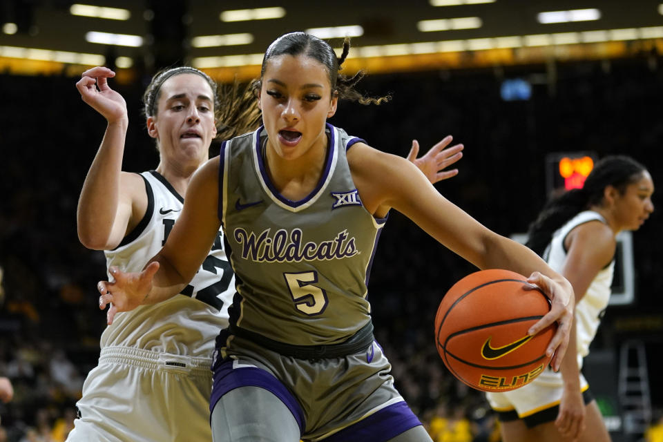 Kansas State guard Brylee Glenn (5) drives around Iowa guard Caitlin Clark (22) during the first half of an NCAA college basketball game, Thursday, Nov. 16, 2023, in Iowa City, Iowa. (AP Photo/Charlie Neibergall)