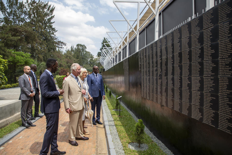 Britain's Prince Charles and Camilla, Duchess of Cornwall, observe the wall of names next to the mass graves at the Kigali Genocide Memorial in the capital Kigali, Rwanda Wednesday, June 22, 2022. Prince Charles has become the first British royal to visit Rwanda, representing Queen Elizabeth II as the ceremonial head of the Commonwealth at a summit where both the 54-nation bloc and the monarchy face uncertainty. (AP Photo)