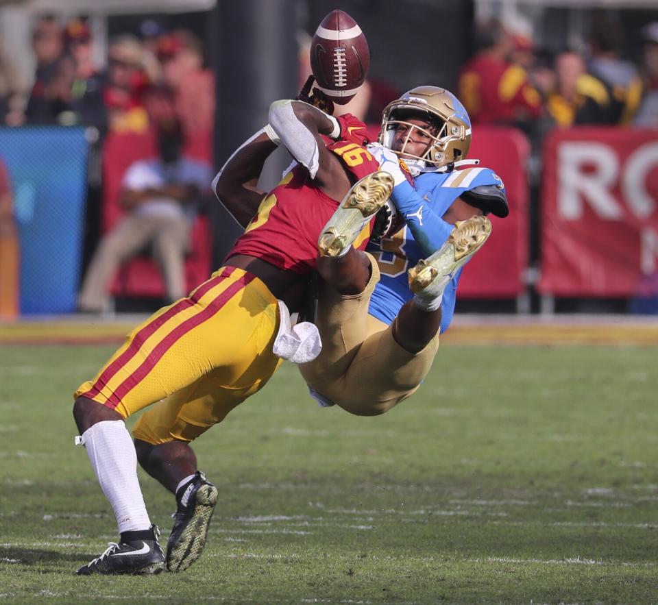 UCLA cornerback Cameron Johnson bats a pass away from USC wide receiver Tahj Washington.