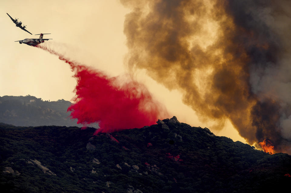 An air tanker drops retardant to slow the Cave Fire burning in Los Padres National Forest, Calif., above Santa Barbara on Tuesday, Nov. 26, 2019. (AP Photo/Noah Berger)