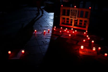 Candles and posters are seen on the ground during a silent candlelight vigil to protest against the assassination of investigative journalist Daphne Caruana Galizia in a car bomb attack two days ago, at the University of Malta in Msida, Malta, October 18, 2017. REUTERS/Darrin Zammit Lupi