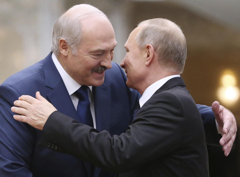 FILE- In this file photo taken on Thursday, Nov. 30, 2017, Belarusian President Alexander Lukashenko, left, greets Russian President Vladimir Putin during the Collective Security Council of the Collective Security Treaty Organization (CSTO) summit in Minsk, Belarus. Putin warned that he stands ready to send police to Belarus if protests there turn violent, but added in an interview broadcast Thursday that there is no such need now and voiced hope for stabilizing the situation in the neighboring country. (Tatyana Zenkovich, Pool Photo via AP, File)