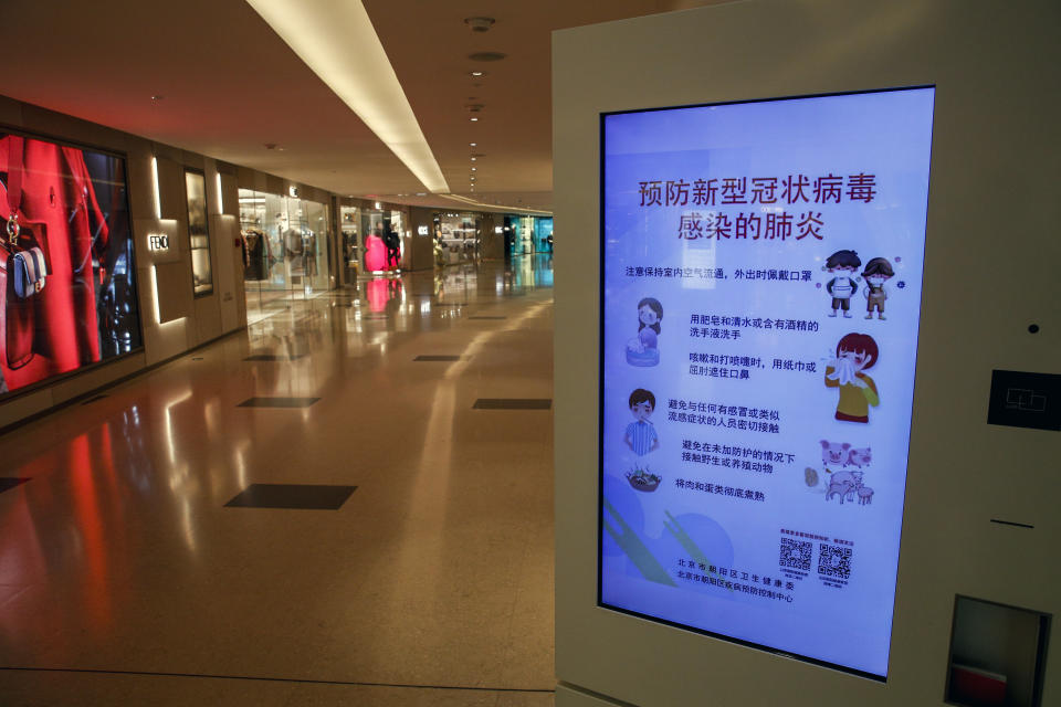 FILE - In this Feb. 9, 2020, file photo, an electronic display board showing a precautionary notice of the coronavirus at a deserted upscale shopping mall in Beijing. Chinese authorities are struggling to strike a delicate balance between containing a deadly viral outbreak and restarting the world’s second-biggest economy after weeks of paralysis. (AP Photo/Andy Wong, File)
