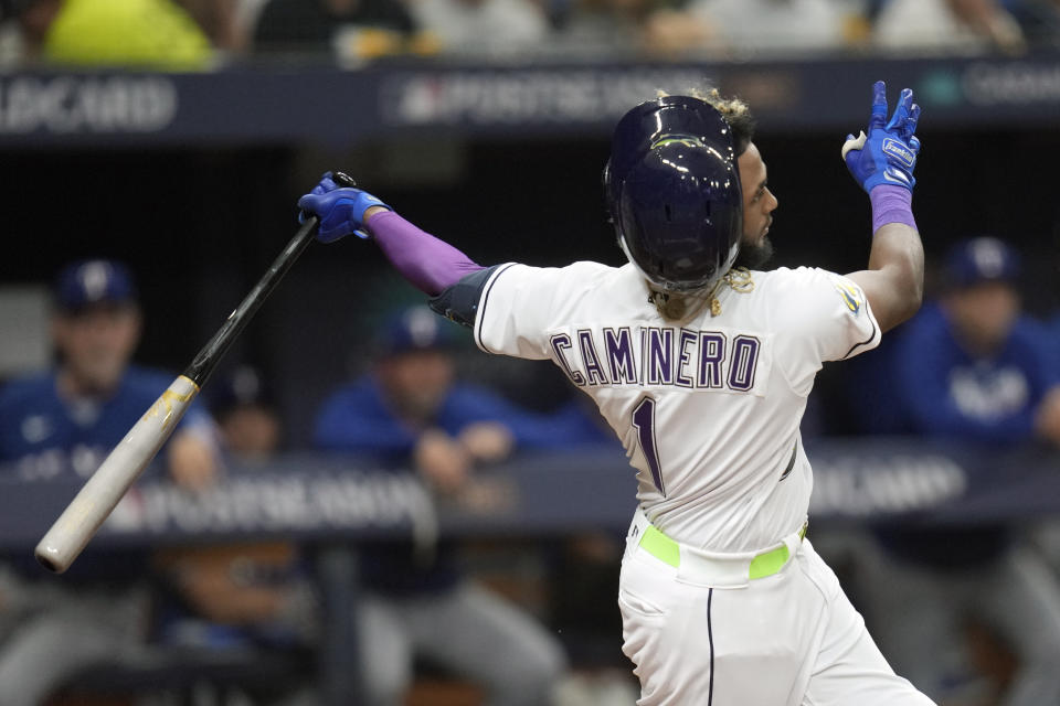 Tampa Bay Rays' Junior Caminero (1) loses his helmet as he hits a foul ball during the sixth inning of Game 1 in the team's AL wild-card baseball playoff series against the Texas Rangers on Tuesday, Oct. 3, 2023, in St. Petersburg, Fla. (AP Photo/John Raoux)