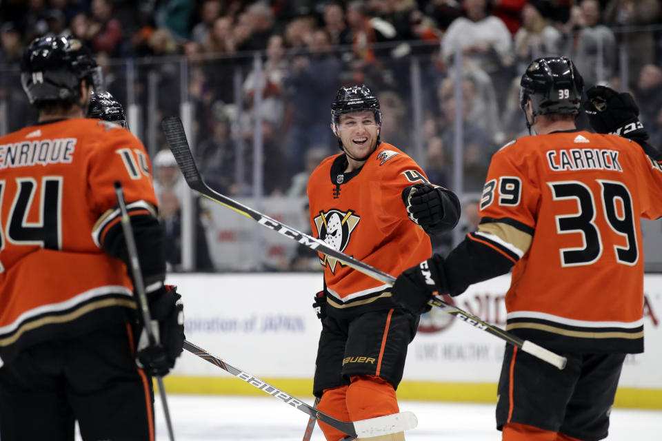Anaheim Ducks' Cam Fowler, center, celebrates his goal with Adam Henrique, left, and Sam Carrick (39) during the second period of an NHL hockey game against the Vegas Golden Knights on Friday, Dec. 27, 2019, in Anaheim, Calif. (AP Photo/Marcio Jose Sanchez)