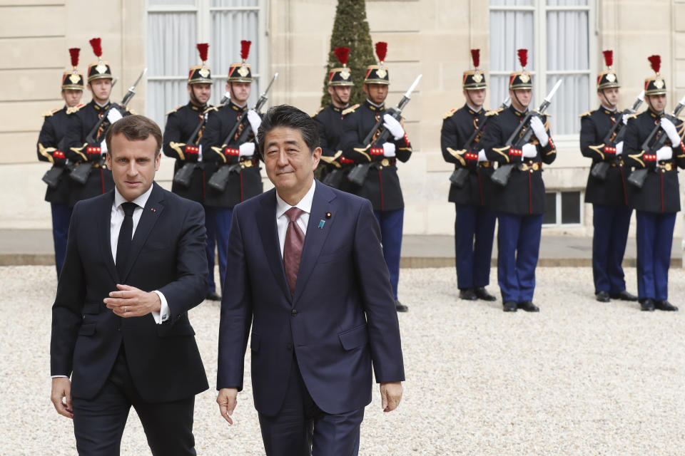 French President Emmanuel Macron, left, welcomes Japan's Prime Minister Shinzo Abe before their talks at the Elysee Palace, Tuesday, April 23, 2019 in Paris. (AP Photo/Thibault Camus)