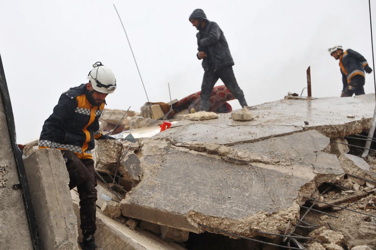 Members of the Syrian civil defence, known as the White Helmets search for survivors under the rubble following an earthquake in the town of Zardana in the countryside of the northwestern Syrian Idlib province (AFP via Getty Images)