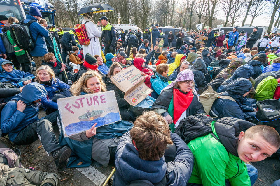 THE HAGUE, NETHERLANDS - 2024/02/03: Extinction Rebellion activists glued to the ground wait to be removed during the demonstration. Police removed 1,000 climate activists from the A12 in The Hague, relocating them to the ADO football stadium, where they were released. Extinction Rebellion members blocked the motorway for the first time in four months, despite the presence of water cannons. Last year, the group blocked the A12 numerous times until actions were suspended on October 10. A motion by the House of Representatives to phase out subsidies to the fossil industry was adopted but not implemented. Outgoing Climate Minister Jetten pledged suggestions for subsidy phase-out to the next cabinet. (Photo by Charles M. Vella/SOPA Images/LightRocket via Getty Images)