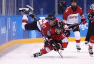 <p>Shoko Ono #27 of Japan falls on top of Dominique Ruegg #26 of Switzerland in the second period during the Women’s Ice Hockey Preliminary Round – Group B game on day three of the PyeongChang 2018 Winter Olympic Games at Kwandong Hockey Centre on February 12, 2018 in Gangneung, South Korea. (Photo by Bruce Bennett/Getty Images) </p>