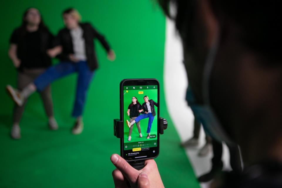 Jane Wickline and Grace Reiter perform on a green screen on the set of "Stapleview" while being filmed.