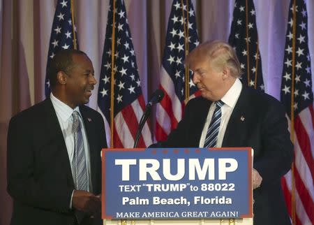 Republican U.S. presidential candidate Donald Trump (R) shakes hands with former Republican presidential candidate Ben Carson after receiving Carson's endorsement at a campaign event in Palm Beach, Florida March 11, 2016. REUTERS/Carlo Allegri