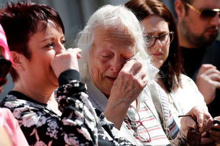 People react before a minute of silence for the victims of the Manchester Arena attack, in St Ann's Square, in central Manchester, Britain May 25, 2017. REUTERS/Stefan Wermuth TPX IMAGES OF THE DAY