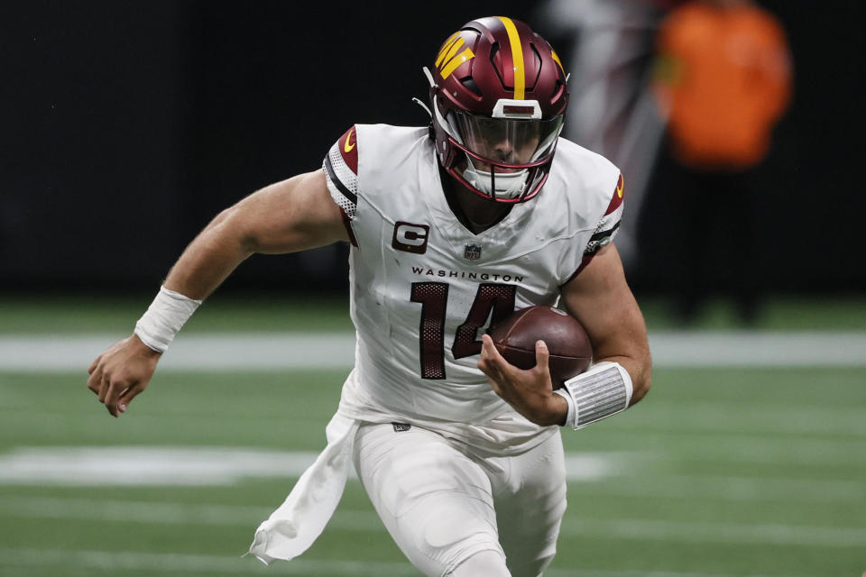 Washington Commanders quarterback Sam Howell (14) runs against the Atlanta Falcons during the first half of an NFL football game, Sunday, Oct. 15, 2023, in Atlanta. (AP Photo/Butch Dill)