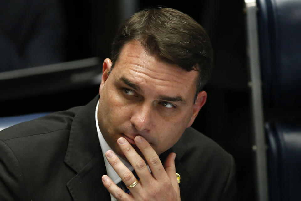 Brazilian Senator Flavio Bolsonaro, son of the nation's president, attends the final voting session on pension reform at the Senate in Brasilia, Brazil, Tuesday, Oct. 22, 2019. The most meaningful impact of the reform is the establishment of a minimum age for retirement at 65 for men and 62 for women. (AP Photo/Eraldo Peres)