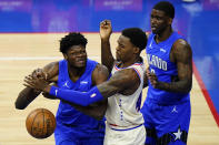 Orlando Magic's Mo Bamba, left, cannot get a shot past Philadelphia 76ers' Paul Reed, center, as Dwayne Bacon looks on during the second half of an NBA basketball game, Sunday, May 16, 2021, in Philadelphia. (AP Photo/Matt Slocum)