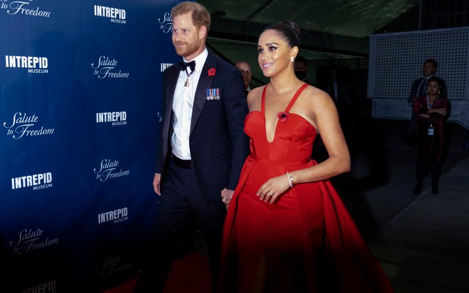 Prince Harry and Meghan Markle, Duke and Duchess of Sussex, arrive at the Intrepid Sea, Air & Space Museum for the Salute to Freedom Gala Wednesday, Nov. 10, 2021, in New York. The Duke of Sussex will also present the inaugural Intrepid Valor Award to five service members, veterans and their military families. (AP Photo/Craig Ruttle) - AP