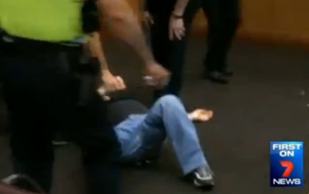 Farouk Abdulrahim rests on the floor after the fight. Source: Kate Jones/ 7 News.