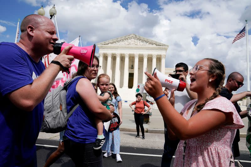 Abortion rights activists and counter protesters protest outside the U.S. Supreme Court, in Washington