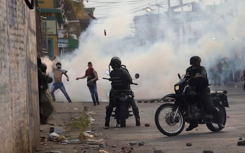 Venezuelan demonstrators clash with security forces in Urena, Venezuela, - Credit: Reuters