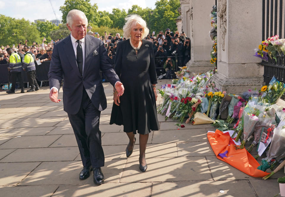 King Charles III and the Queen view tributes left outside Buckingham Palace, London, following the death of Queen Elizabeth II on Thursday. Picture date: Friday September 9, 2022.