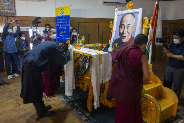 President of the Central Tibetan Administration Penpa Tsering, offers a ceremonial scarf in front of a portrait of his spiritual leader the Dalai Lama during a ceremony to mark the 86th birthday of the Tibetan leader in Dharmsala, India, Tuesday, July 6, 2021. This year, due to the coronavirus pandemic, the celebrations were muted and behind closed doors. (AP Photo/Ashwini Bhatia)