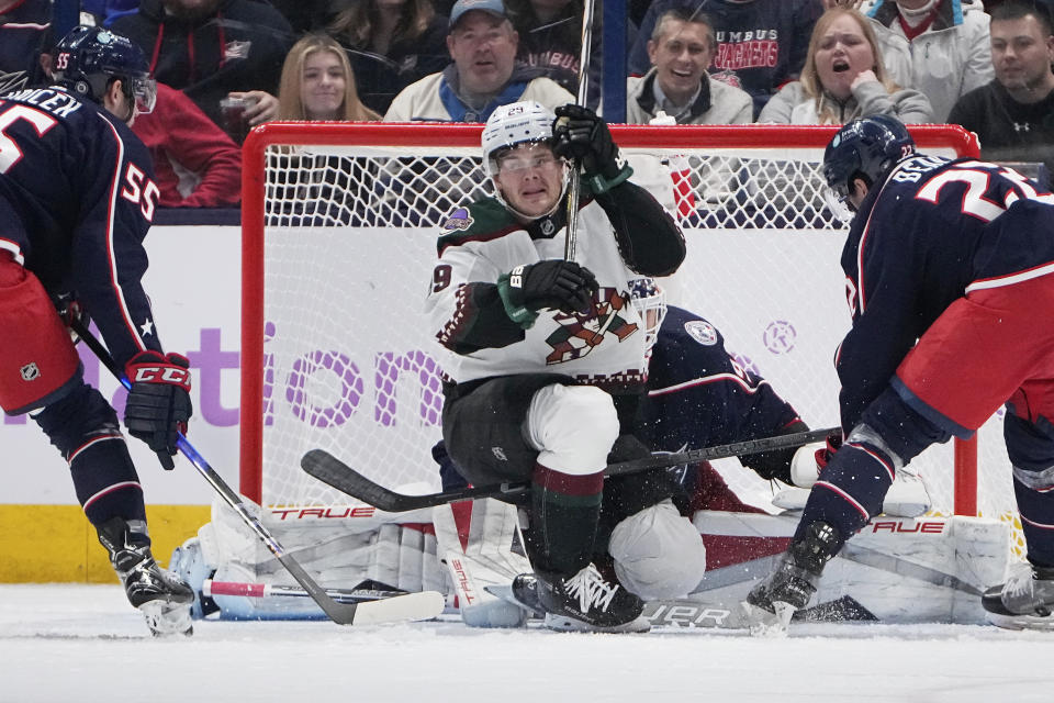 Arizona Coyotes center Barrett Hayton (29) celebrates after scoring on Columbus Blue Jackets goaltender Elvis Merzlikins, rear, during the second period of an NHL hockey game Thursday, Nov. 16, 2023, in Columbus, Ohio. (AP Photo/Sue Ogrocki)