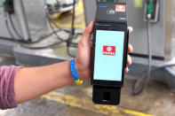 A worker shows the device of the Venezuela's new digital fuel payment system at a gas station of the Venezuelan state-owned oil company PDVSA in Caracas, Venezuela September 24, 2018. REUTERS/Marco Bello