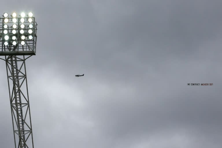 A plane flies over the Hawthorns stadium trailing an anti-Arsene Wenger banner during the Premier League match between West Bromwich Albion and Arsenal on March 18, 2017