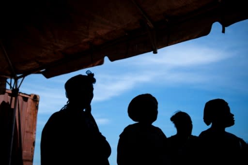 Survivors of Hurricane Dorian wait for family members after arriving in Nassau