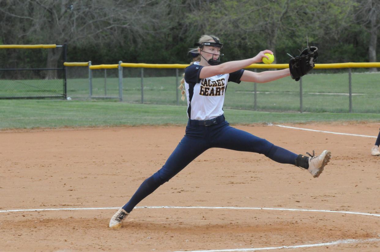 Sacred Heart's Emilee Blythe (12) delivers a pitch during a doubleheader against Wichita Trinity Tuesday, May 3, 2022, at Bill Burke Park.