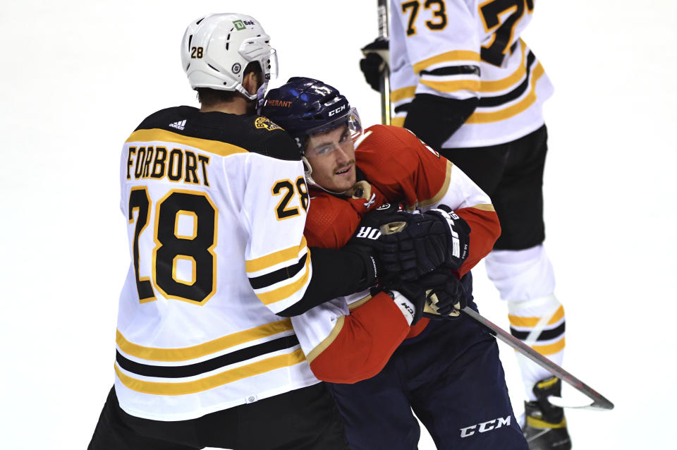 Boston Bruins defenseman Derek Forbort (28) and Florida Panthers defenseman Radko Gudas (7) get into a scrum during the second period of an NHL hockey game Wednesday, Oct. 27, 2021, in Sunrise, Fla. (AP Photo/Jim Rassol)