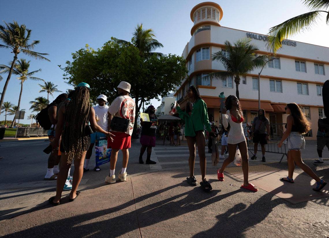 People walk passed the Waldorf Towers down Ocean Drive during spring break on Sunday, March 17, 2024, in South Beach.