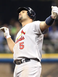 Albert Pujols reacts after hitting a ground-rule double in the seventh inning of the Cards' 12-3 win over the Brewers in Game 2 of the NLCS