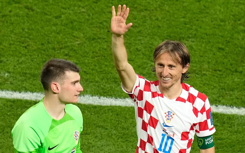 Croatia's Luka Modric, right, waves after the World Cup group F soccer match between Croatia and Canada, at the Khalifa International Stadium - Themba Hadebe/AP