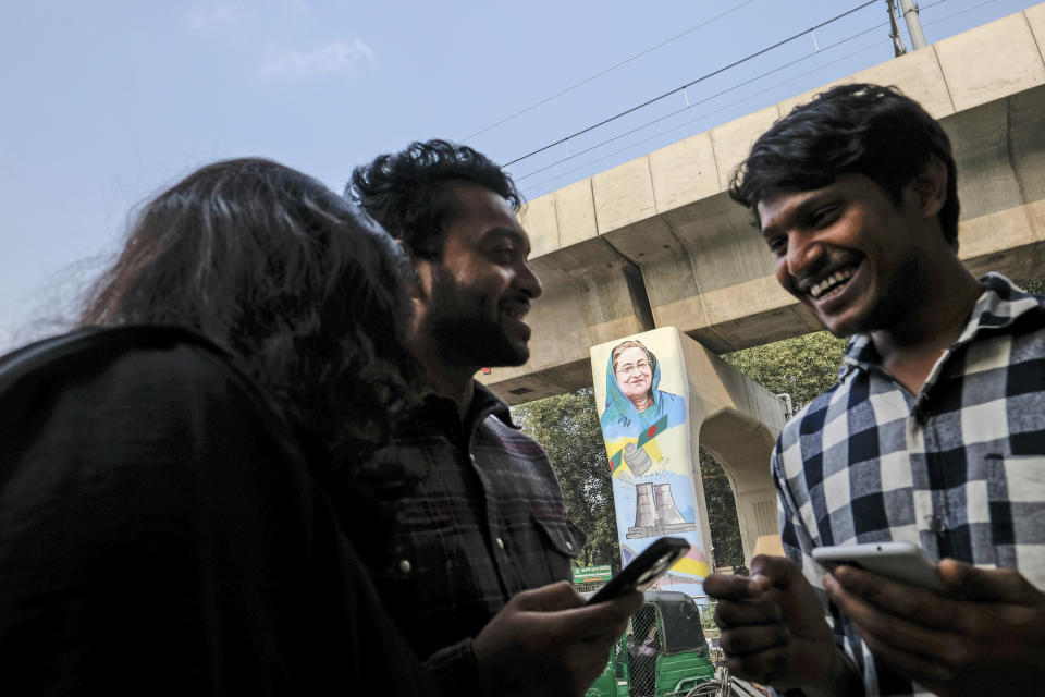 A painting of Prime Minister Sheikh Hasina along with the Bangabandhu Satellite is seen on a metro railway pillar in Dhaka University area, Bangladesh, Dec.21, 2023. For decades, political battles in Bangladesh have been fought on the streets, often with violence, by parties led by two powerful women. But there are signs of a generational change as the country of 169 million heads into another general election Sunday. (AP Photo/Mahmud Hossain Opu)