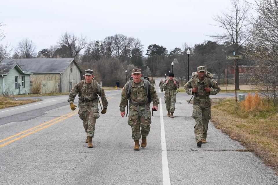Command Sgt. Maj. Craig Hood, center, leads a ruck march alongside Army Counterintelligence Command soldiers during a Best Squad competition at Fort Meade, Maryland, March 10, 2023.