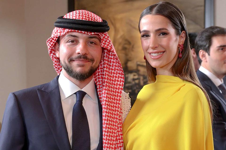 <p>Jordanian Royal Court/Getty Images</p> Crown Prince Hussein and Princess Rajwa attend the wedding of Princess Iman in March 2023