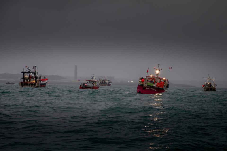 <p>French fishing vessels stage a protest at St Helier</p> (PA)