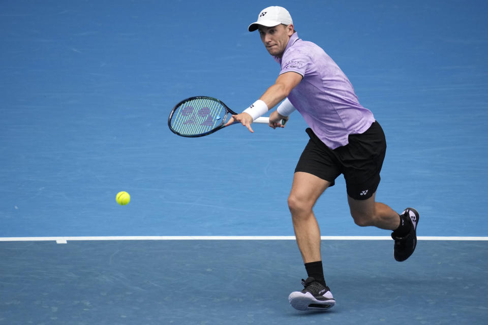 Casper Ruud of Norway plays a forehand return to Jenson Brooksby of the U.S. during their second round match at the Australian Open tennis championship in Melbourne, Australia, Thursday, Jan. 19, 2023. (AP Photo/Dita Alangkara)