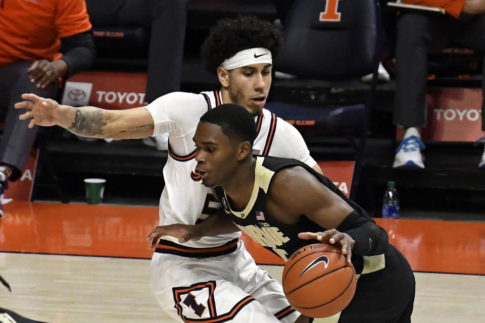 Purdue's guard Eric Hunter Jr. (2) powers past Illinois guard Andre Curbelo (5) in the first half of an NCAA college basketball game Saturday, Jan. 2, 2021, in Champaign, Ill. (AP Photo/Holly Hart)