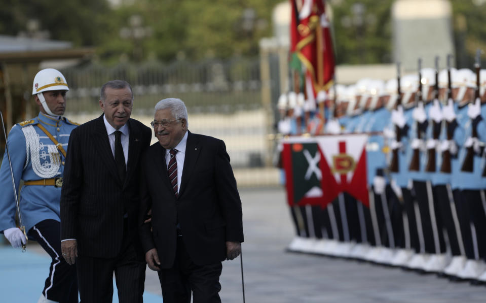 Turkey's President Recep Tayyip Erdogan, left, and Palestinian President Mahmoud Abbas review a military honour guard during a welcome ceremony in Ankara, Turkey, Tuesday, Aug. 23, 2022. Abbas is in Turkey for a two-day state visit.(AP Photo/Burhan Ozbilici)