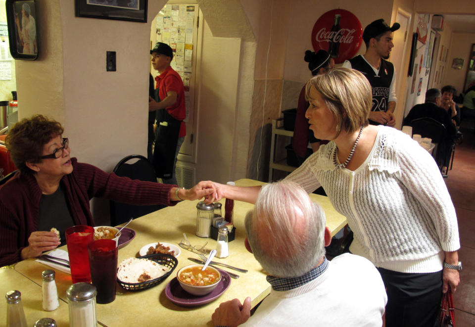 In this Oct. 19, 2012 photo, Michelle Lujan Grisham, a Democrat who became New Mexico's first Latina elected to Congress after winning the state's open 1st Congressional District race on Tuesday, Nov. 6, 2012, is shown speaking with Hispanic voters at Barelas Coffee House in Albuquerque, N.M. Among many troubling signs for Republicans Tuesday night was the continued drift of Hispanics _ the nation’s fastest-growing ethnic group _ into the blue column. Republican Mitt Romney backed hardline immigration measures during the primary and won only 27 percent of the Hispanic vote Tuesday, less than any presidential candidate in 16 years. (AP Photo/Russell Contreras)