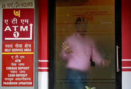 FILE PHOTO: A man leaves an automated teller machine (ATM) facility of Punjab National Bank (PNB) in New Delhi, India, February 27, 2018. REUTERS/Saumya Khandelwal/File photo