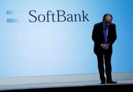 FILE PHOTO: Japan's SoftBank Group Corp Chief Executive Masayoshi Son bows his head after his presentation at a news conference in Tokyo