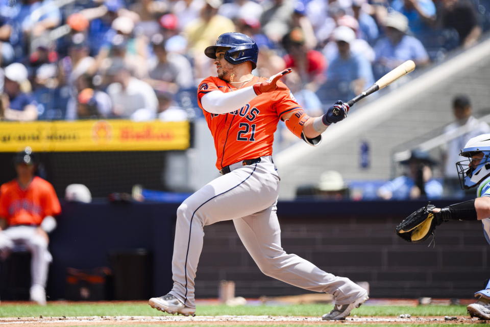 Houston Astros catcher Yainer Diaz (21) hits an RBI single during the first inning of a baseball game against the Toronto Blue Jays in Toronto on Thursday, July 4, 2024. (Christopher Katsarov/The Canadian Press via AP)