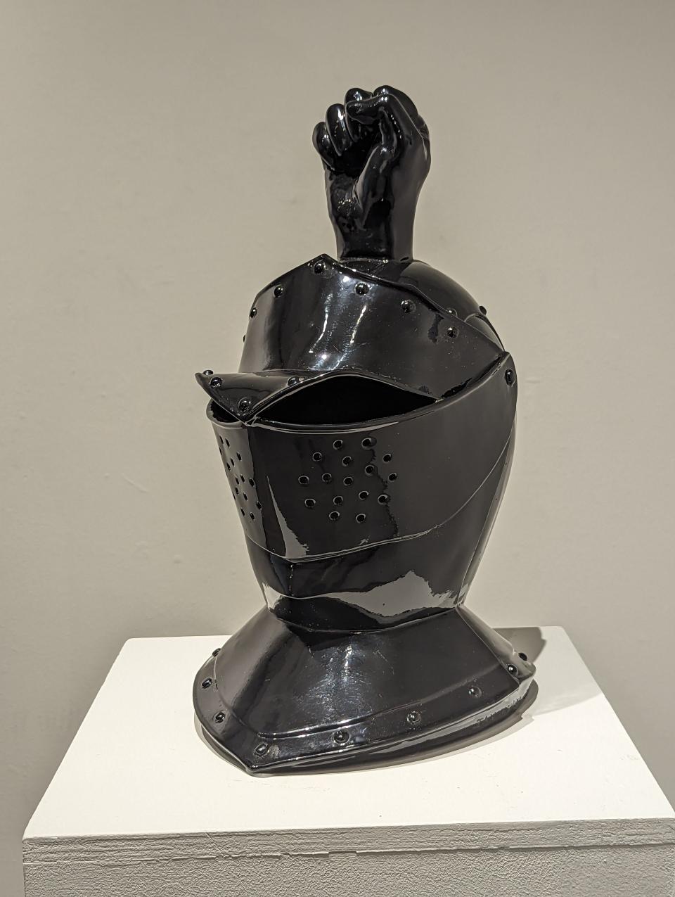 This suit of armor helmet with a Black Power fist as its plumage will be featured in the exhibit "WAKE: Ian Weaver" from Aug. 21 to Sept. 13, 2023, at the Moreau Gallery on the campus of Saint Mary's College. Part of the exhibit includes works that depict Weaver's fictional history for Chicago's displaced "Black Bottom" community, including a fictional group, the Black Knights. The Black Knights works merge his interest in medieval heraldry and Black activism.