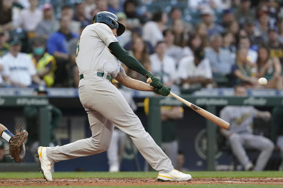 Oakland Athletics' Matt Olson hits a solo home run during the fourth inning of the team's baseball game against the Seattle Mariners, Friday, July 23, 2021, in Seattle. (AP Photo/Ted S. Warren)